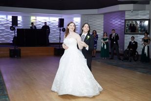 A couple is dancing in their wedding dress.