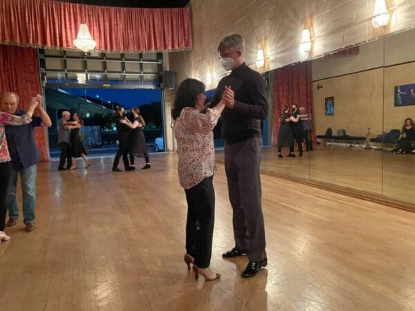 A man and woman dancing in a dance studio.