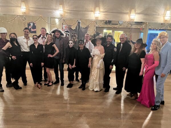 A group of people in black and white costumes.