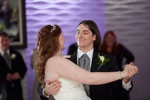A man and woman dancing together at their wedding.