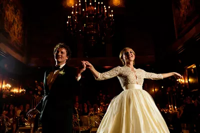 A man and woman in formal wear dancing.